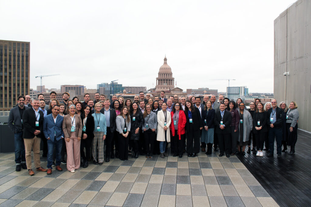 group of architects standing in front of a view of the texas capitol